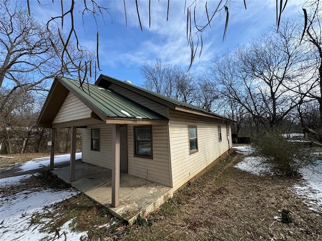 view of side of home featuring metal roof