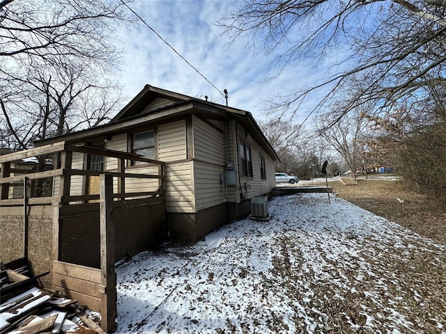 snow covered property featuring central AC