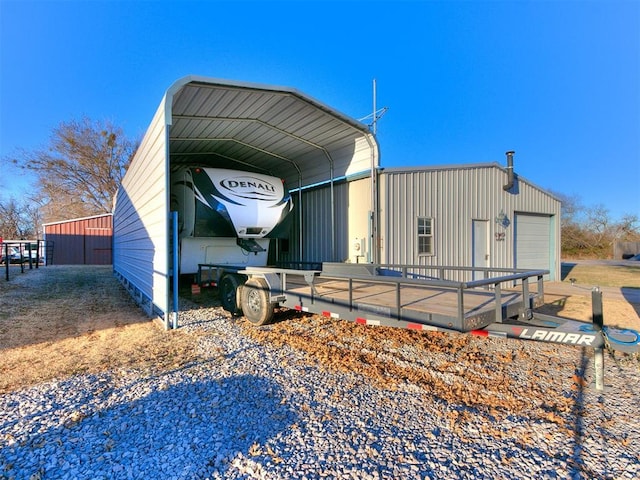 view of side of home with a garage and a carport