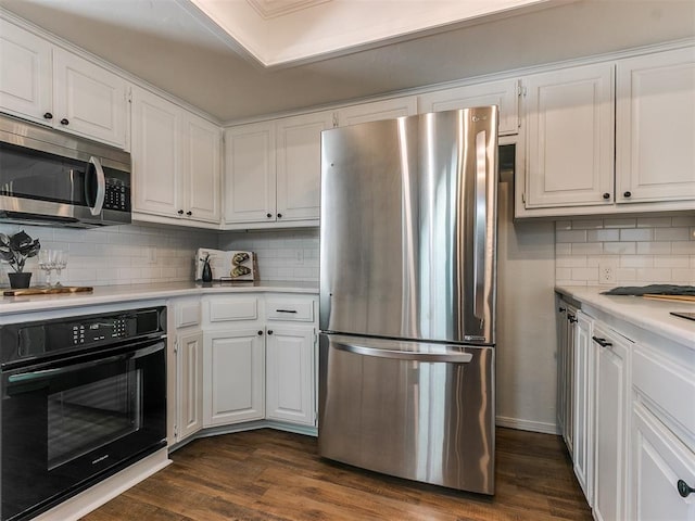 kitchen featuring stainless steel appliances, dark wood-style flooring, light countertops, and white cabinetry