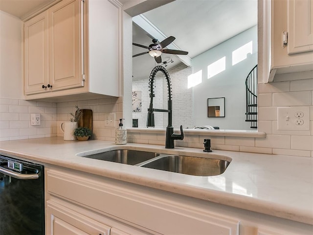 kitchen featuring black dishwasher, tasteful backsplash, and a sink