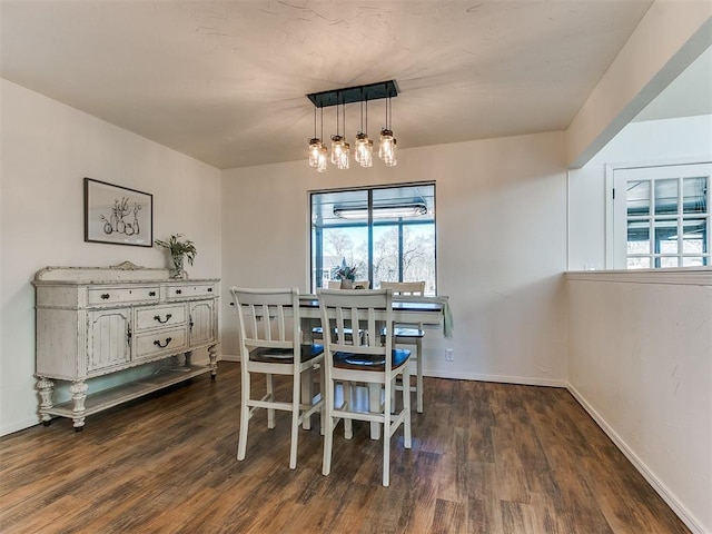 dining room with dark wood-type flooring and baseboards