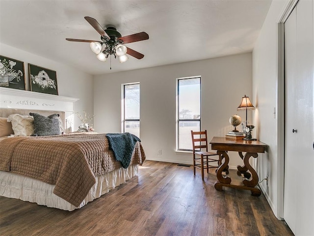 bedroom featuring ceiling fan, wood finished floors, and baseboards