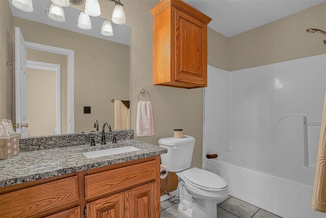 full bath featuring bathing tub / shower combination, vanity, toilet, and tile patterned floors