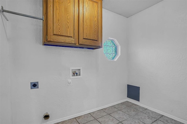 clothes washing area featuring cabinet space, light tile patterned floors, baseboards, hookup for an electric dryer, and washer hookup