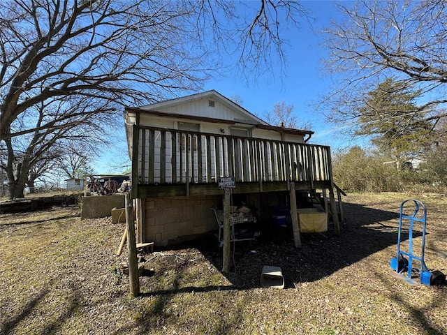 back of property featuring a wooden deck