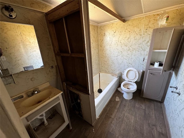 full bathroom with wallpapered walls, toilet, a sink, wood finished floors, and a bath