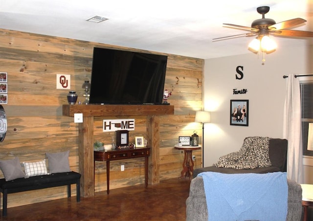 bedroom with finished concrete flooring, visible vents, and wooden walls