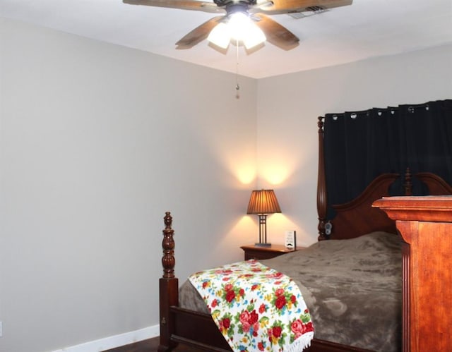 bedroom featuring a ceiling fan and baseboards