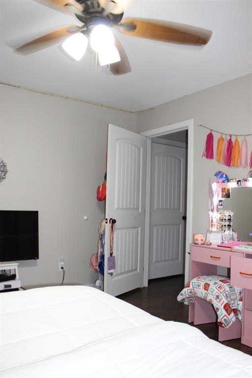 bedroom featuring ceiling fan and wood finished floors