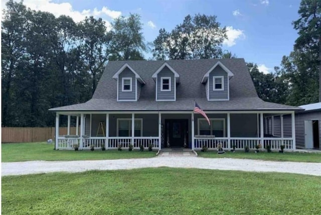 view of front of house featuring a porch, a front yard, fence, and a shingled roof