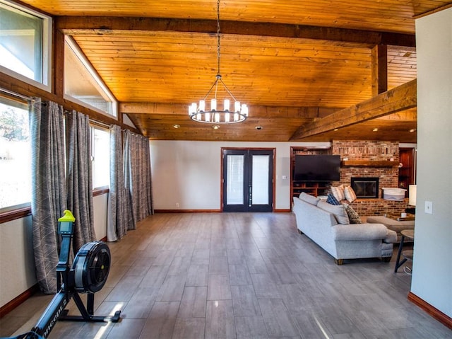 interior space featuring wood finished floors, wood ceiling, baseboards, french doors, and a brick fireplace