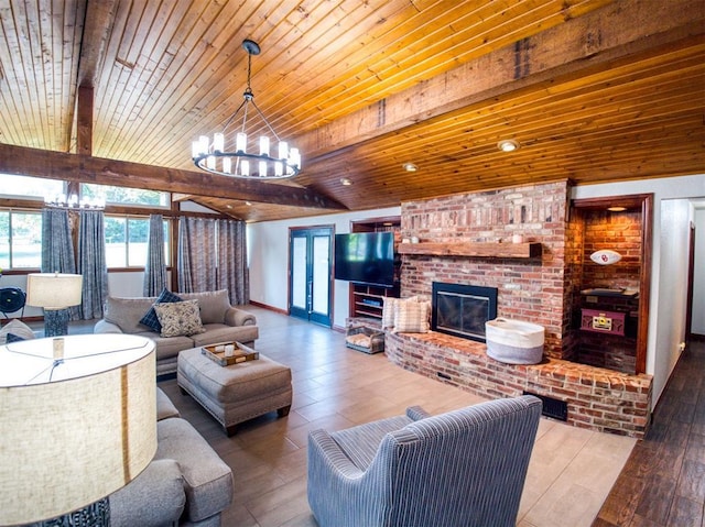 living area with vaulted ceiling with beams, wood ceiling, a fireplace, and a notable chandelier