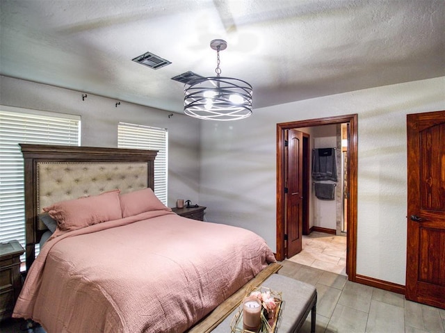 bedroom featuring a textured ceiling, an inviting chandelier, visible vents, and baseboards