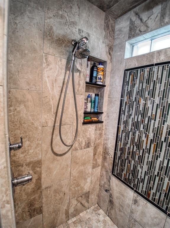 full bath with a tile shower