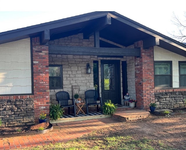 9 Dustin Cir, Shawnee, OK 74804 - entrance to property with a porch, stone siding, and brick siding