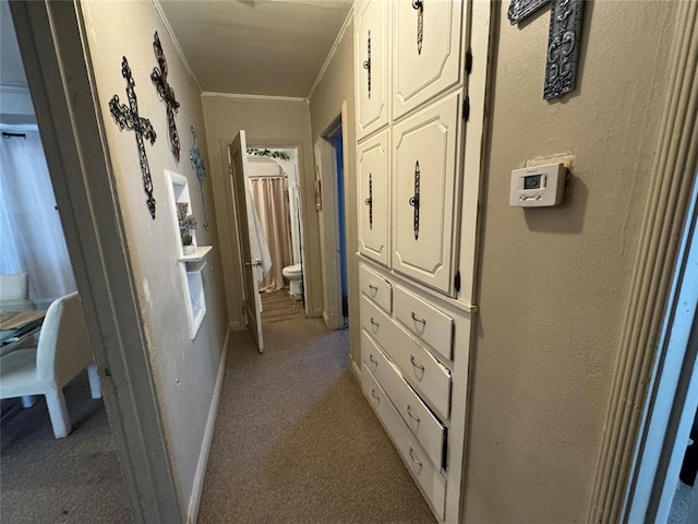 corridor with light carpet, a textured wall, and crown molding