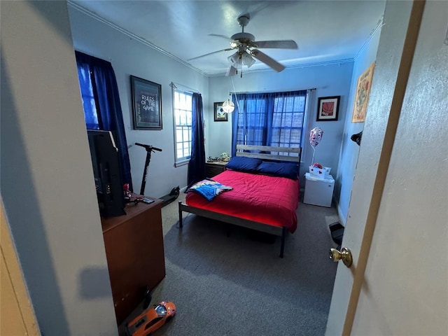 bedroom with ornamental molding and ceiling fan