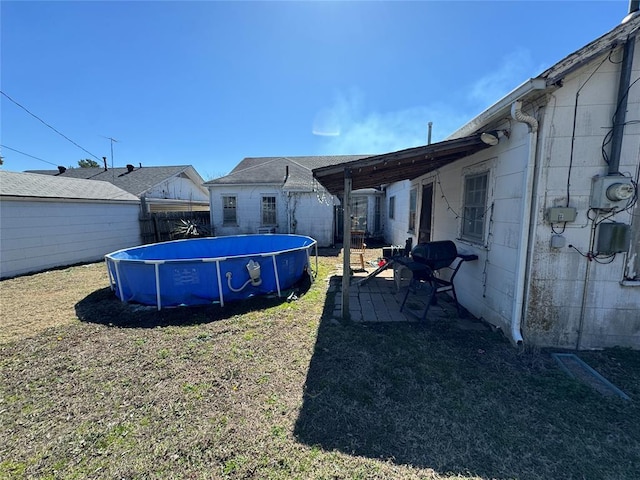 view of yard featuring a patio area, fence, and a fenced in pool