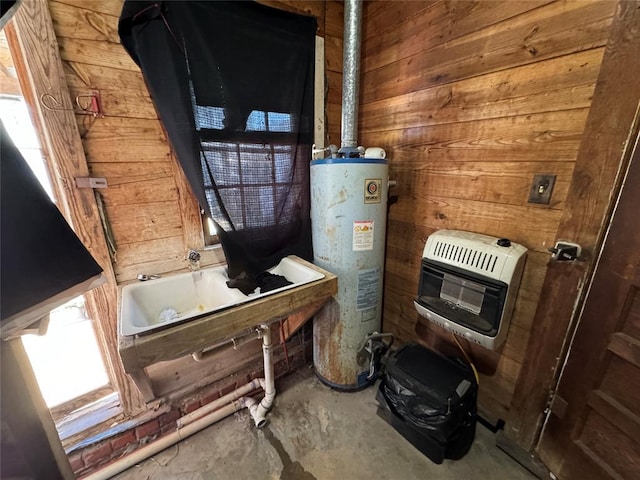 utility room with heating unit, a sink, and gas water heater