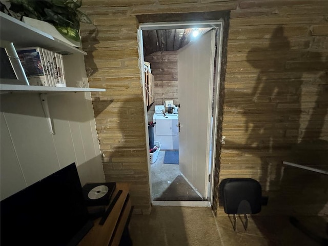 interior space with washer and clothes dryer and wooden walls