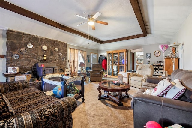 living area with ceiling fan, a tray ceiling, and carpet flooring