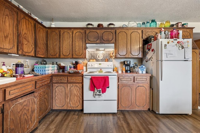 kitchen with white appliances, brown cabinetry, and under cabinet range hood