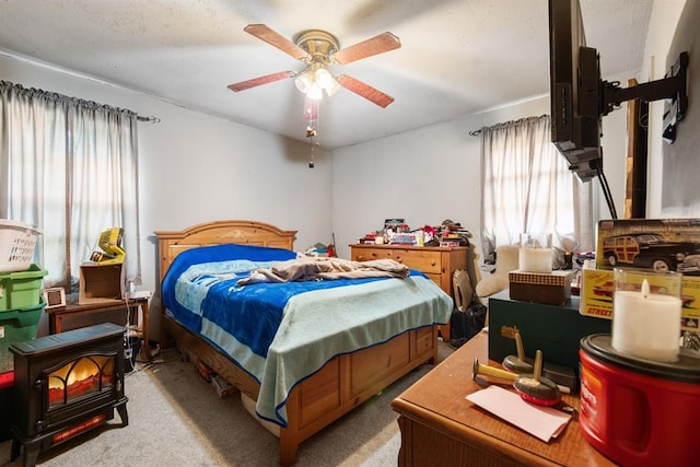 bedroom featuring light carpet and a ceiling fan