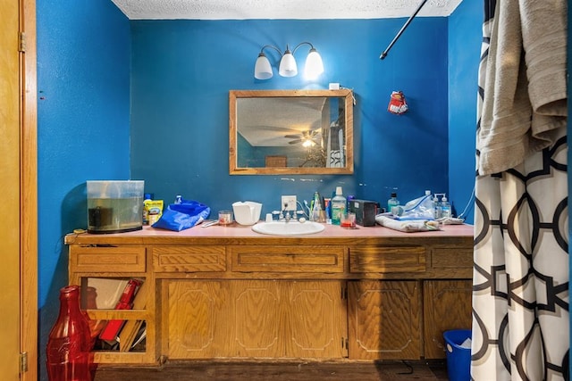 bathroom with a textured ceiling and vanity