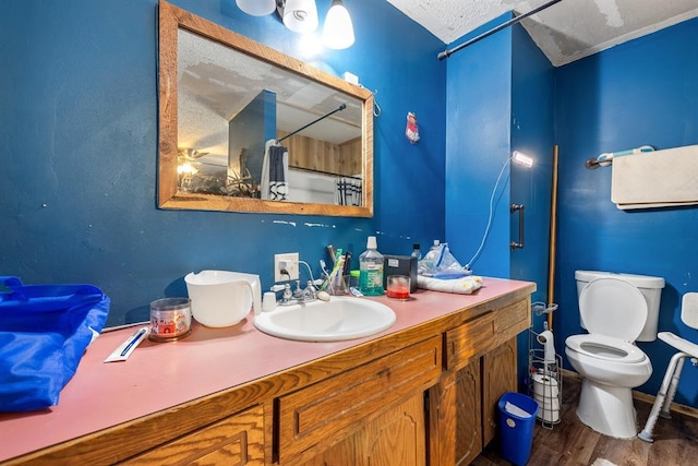 full bathroom featuring wood finished floors, vanity, and toilet