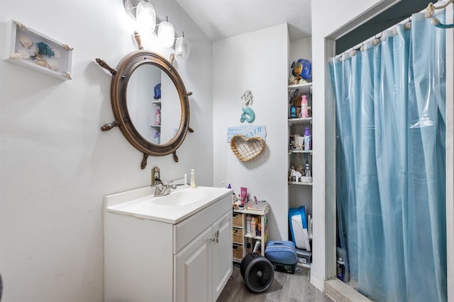 bathroom featuring a shower with curtain, wood finished floors, and vanity