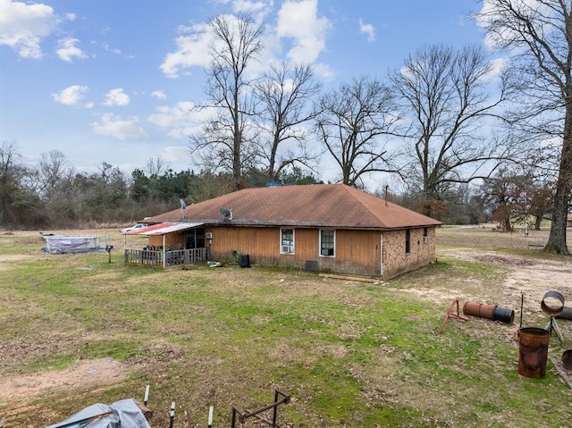 view of side of home with a lawn