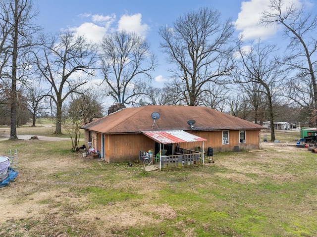 rear view of house with a yard and a chimney