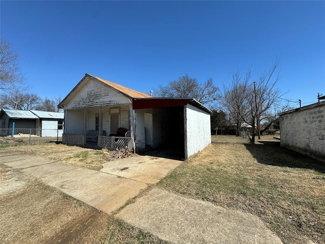 exterior space with covered porch and fence