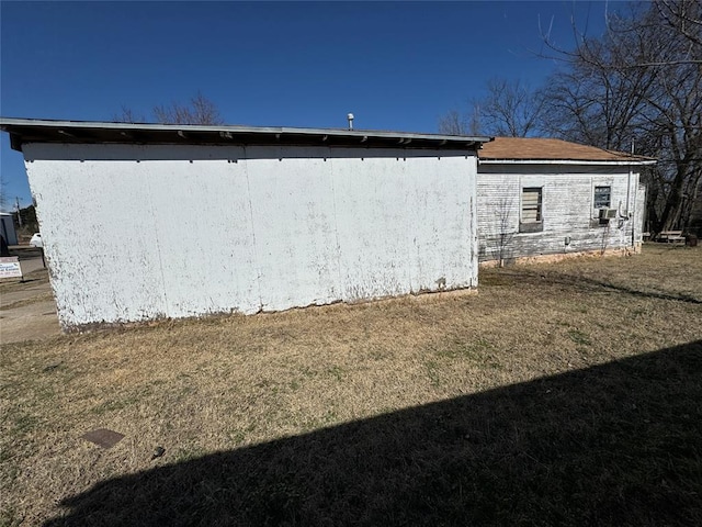 view of side of home featuring a lawn