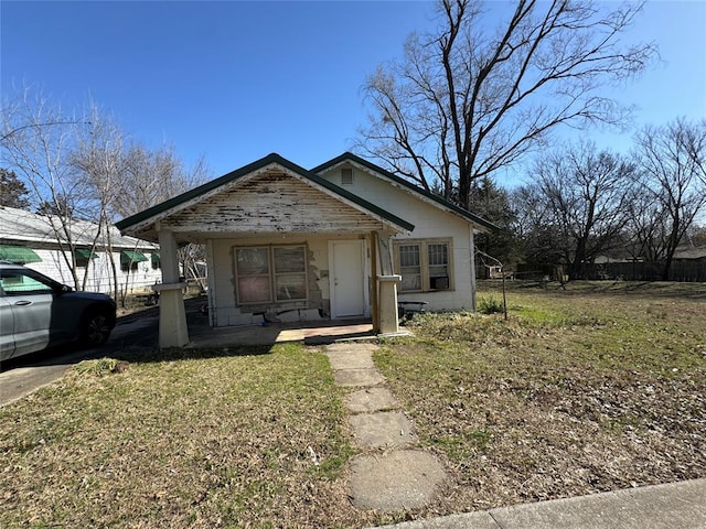 1416 Foster Ave, Seminole, OK 74868 - bungalow-style home featuring a porch, a front lawn, and concrete block siding