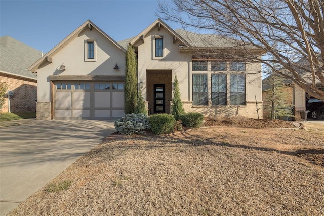 view of front of home with driveway and stucco siding