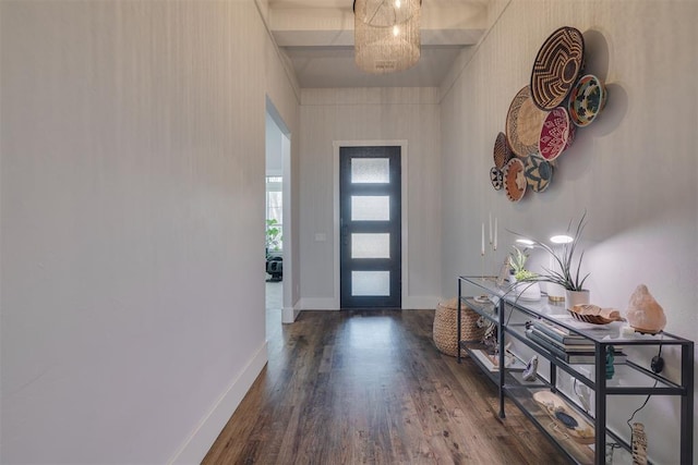 foyer featuring baseboards and dark wood-type flooring