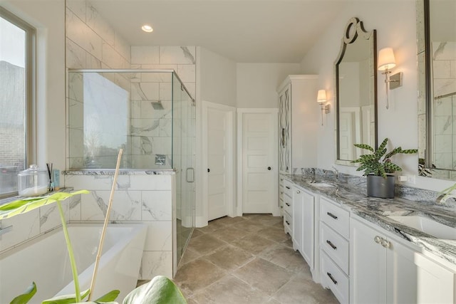 full bathroom with a sink, a freestanding bath, double vanity, and a shower stall