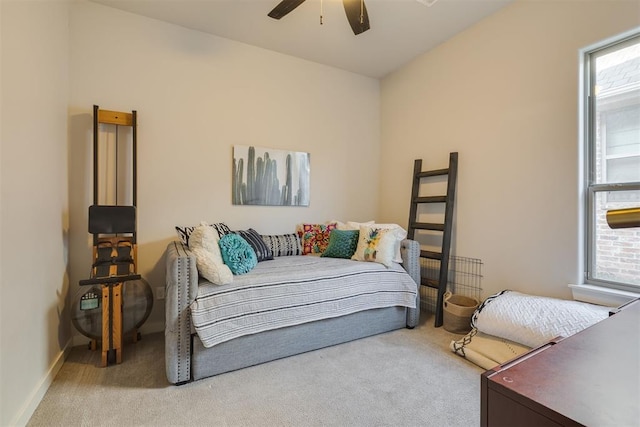 carpeted bedroom featuring baseboards and ceiling fan