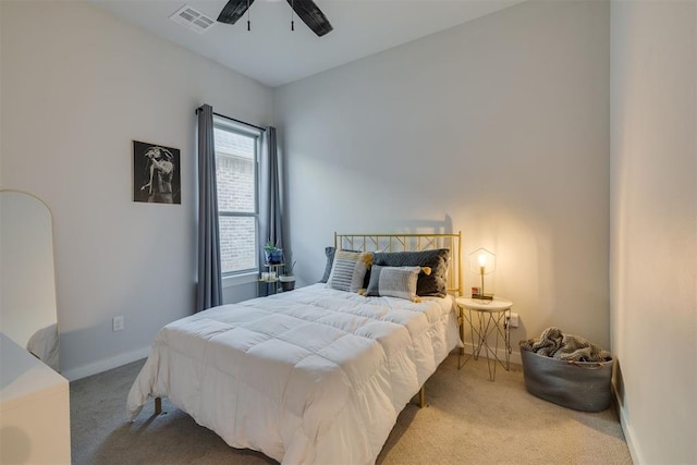 carpeted bedroom with visible vents, baseboards, and a ceiling fan