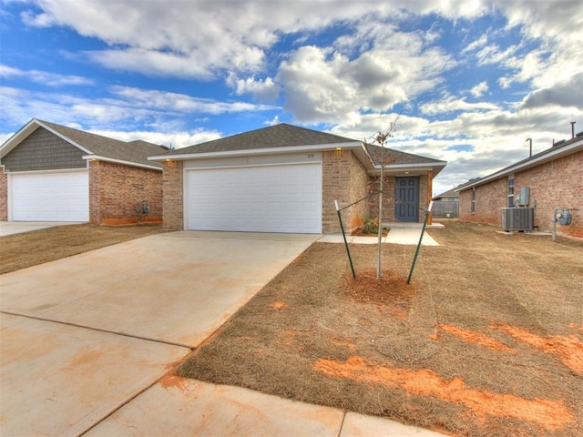 single story home with an attached garage, concrete driveway, cooling unit, and brick siding