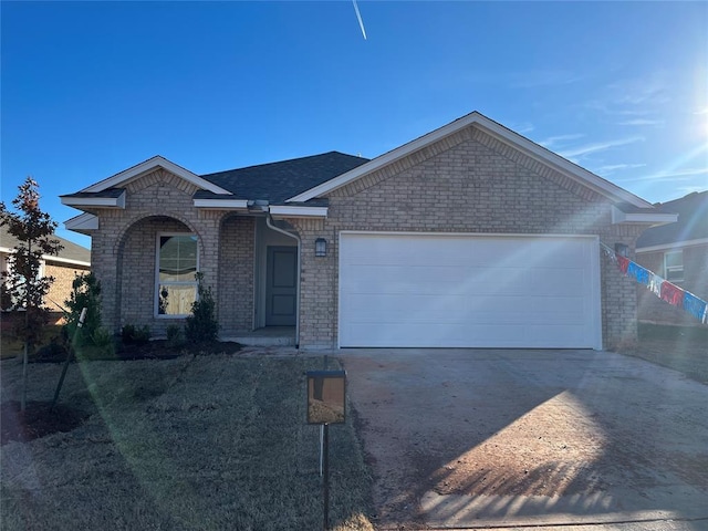 single story home featuring an attached garage, roof with shingles, concrete driveway, and brick siding