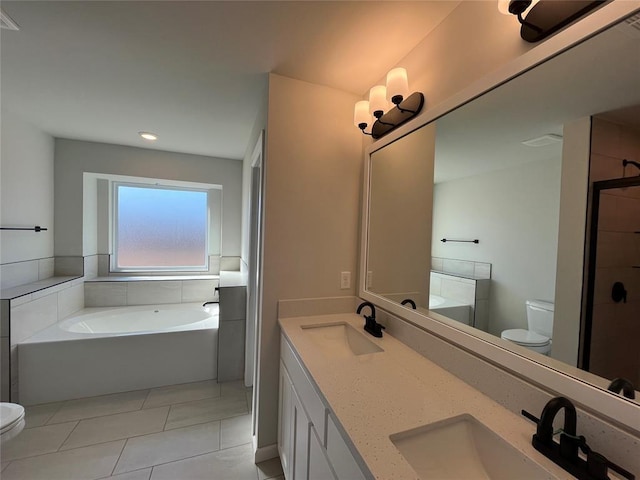 full bathroom featuring a garden tub, a sink, toilet, and double vanity