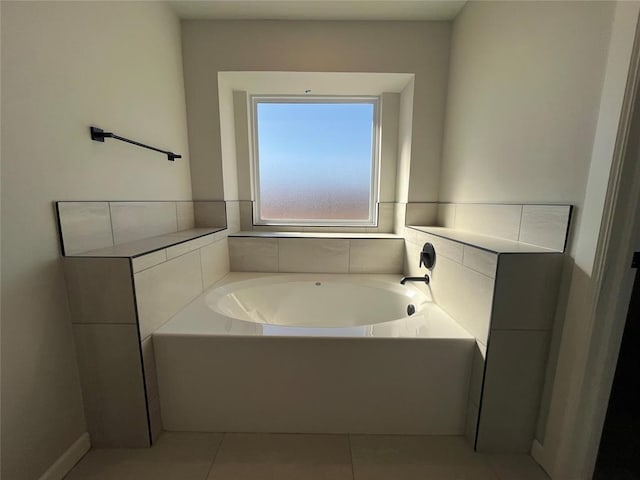 full bath with a garden tub and tile patterned flooring