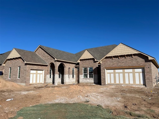 view of front of property featuring a garage and brick siding