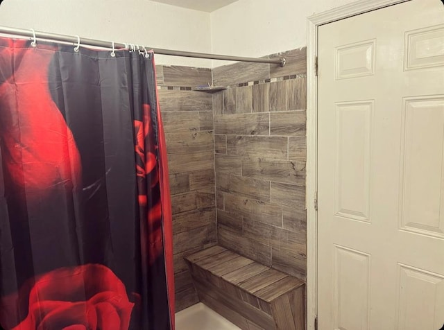 full bath featuring tiled shower