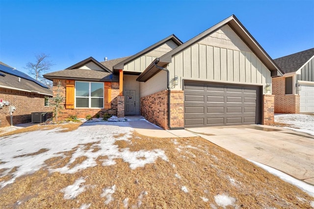 view of front of house with brick siding, concrete driveway, an attached garage, board and batten siding, and cooling unit