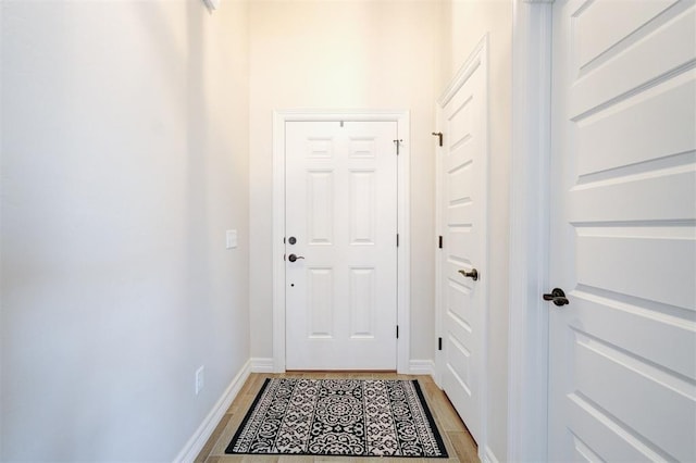 entryway featuring light wood-style floors and baseboards