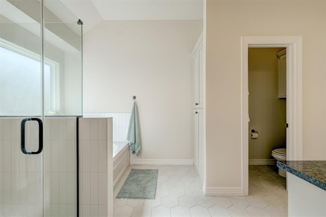 full bathroom with tile patterned flooring, a garden tub, vaulted ceiling, and a shower stall